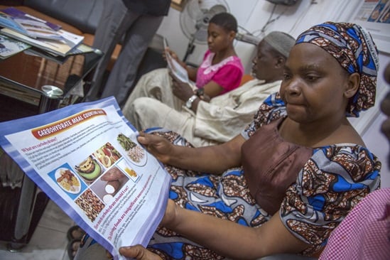 Diabetic patients pass around a carbohydrate counting chart during a diet education session at Rainbow Specialist Medical Center in Lekki, Lagos.