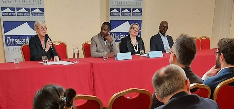 A group of people sitting at a table in a meeting room