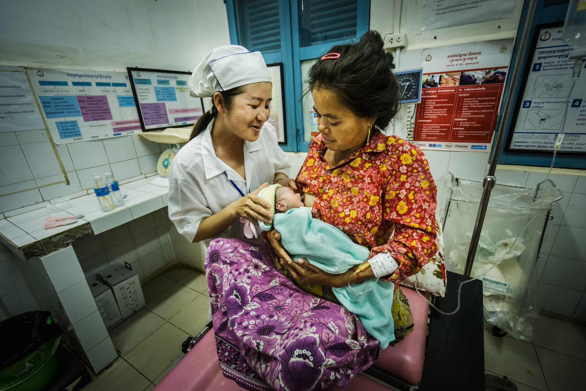 A nurse is assisting a mother breastfeeding in a referral provincial hospital in Cambodia A nurse is assisting a mother breastfeeding in a referral provincial hospital in Cambodia