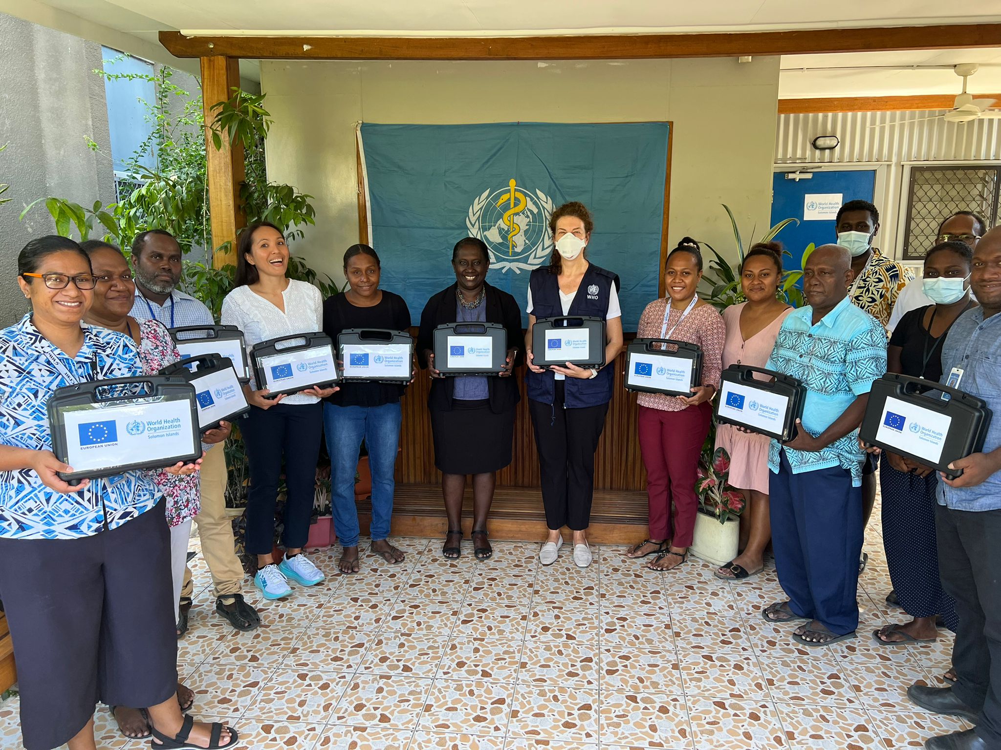 Group photo with WHO and Ministry of Health and Medical Services holding the thermal ablation devices during the official handover headed by MHMS Permanent Secretary Mrs. Pauline McNeil and WHO Solomon Islands Officer in Charge Dr Sonja Tanevska.
